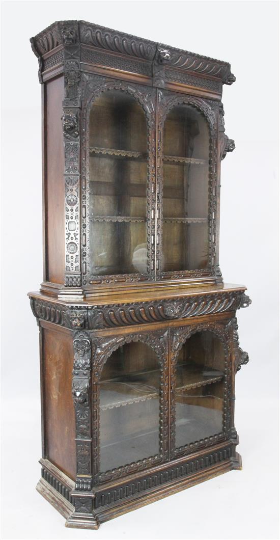 A late 19th century Flemish carved oak bookcase display cabinet, W. 3ft 8in. D. 1ft 7in. H. 7ft 3in.